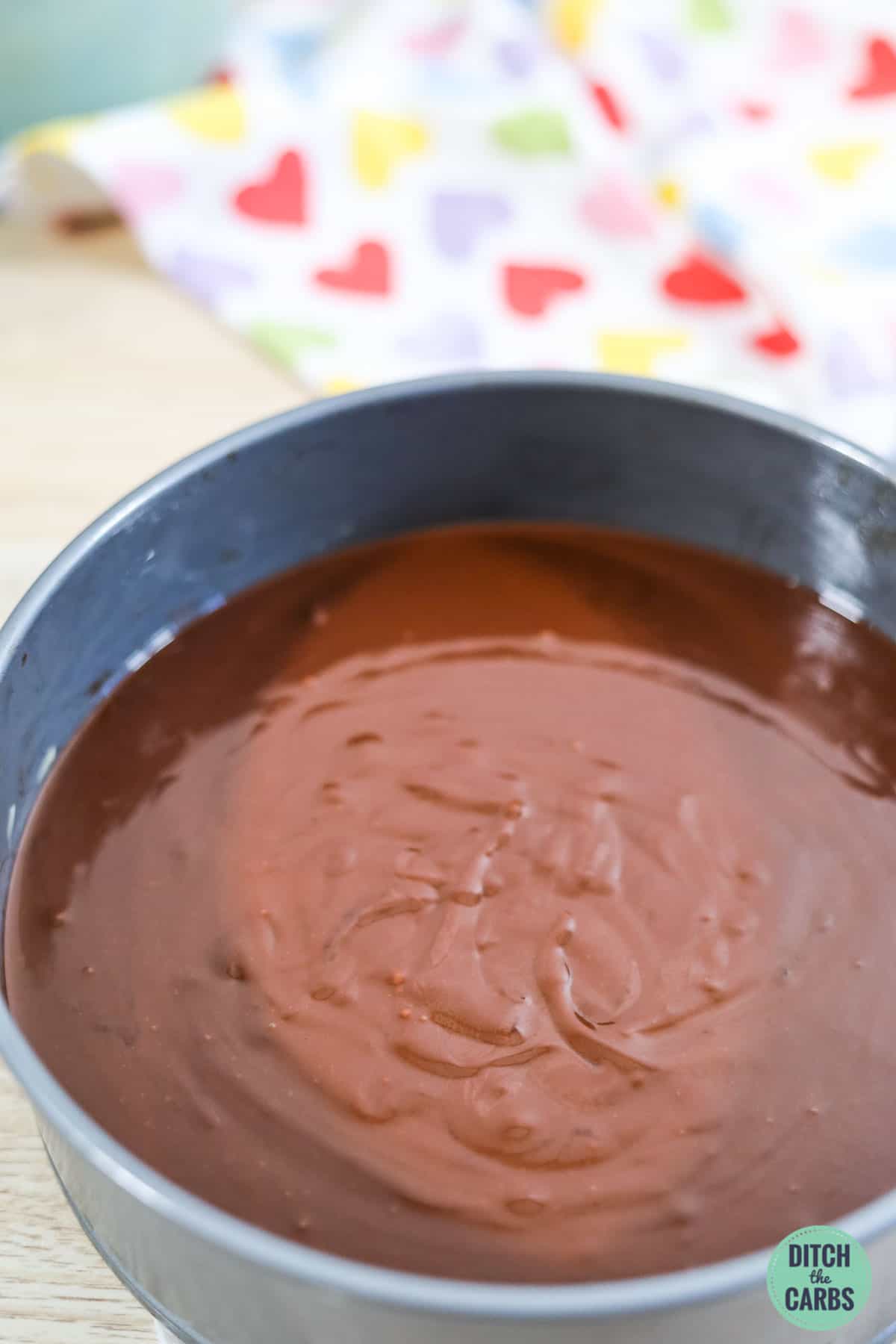 flourless chocolate cake batter in a lined pan