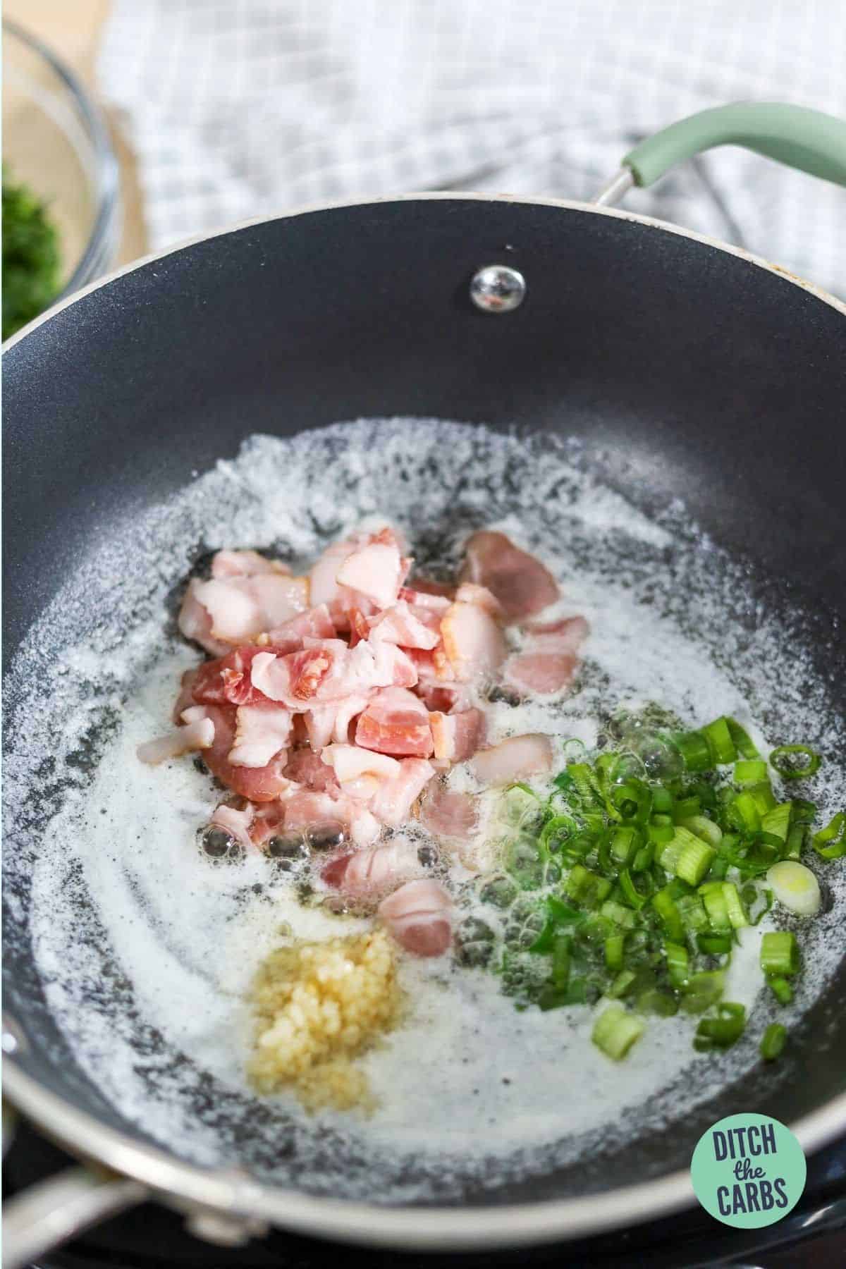 bacon and garlic in a frying pan