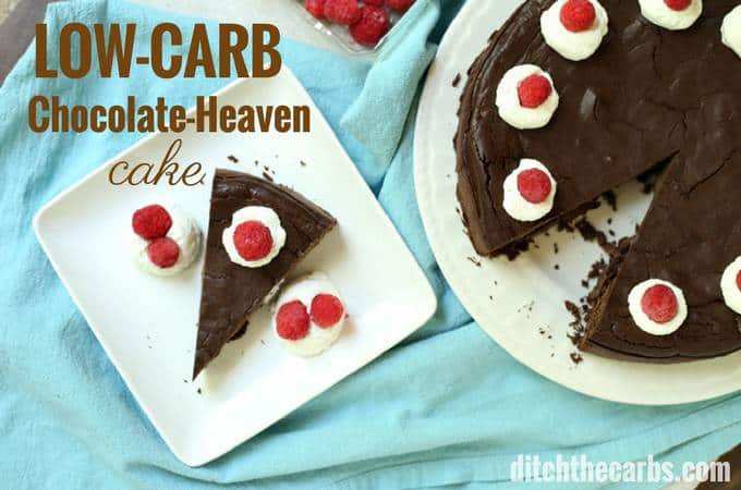 low-carb chocolate-heaven cake served with whipped cream and berries on a white plate