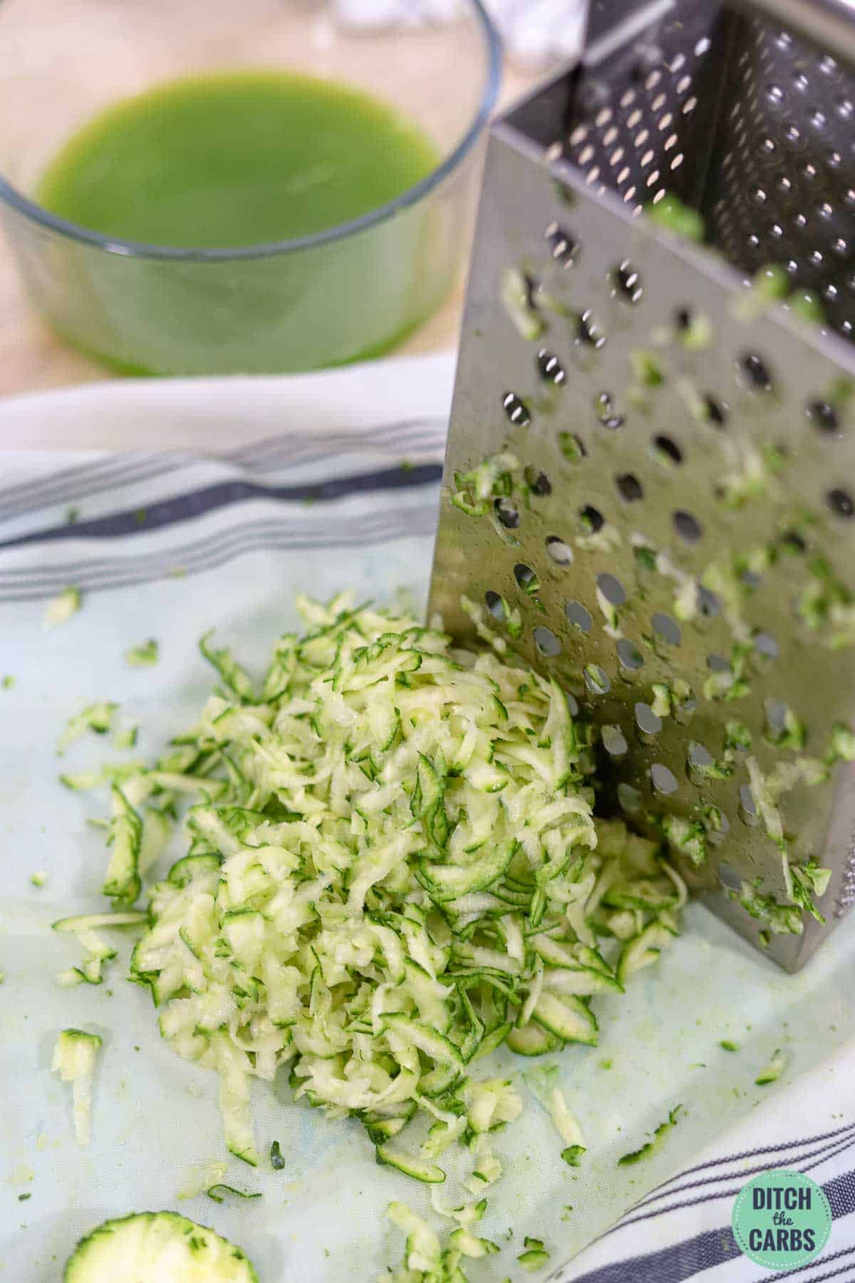 grated zucchini and a metal grater