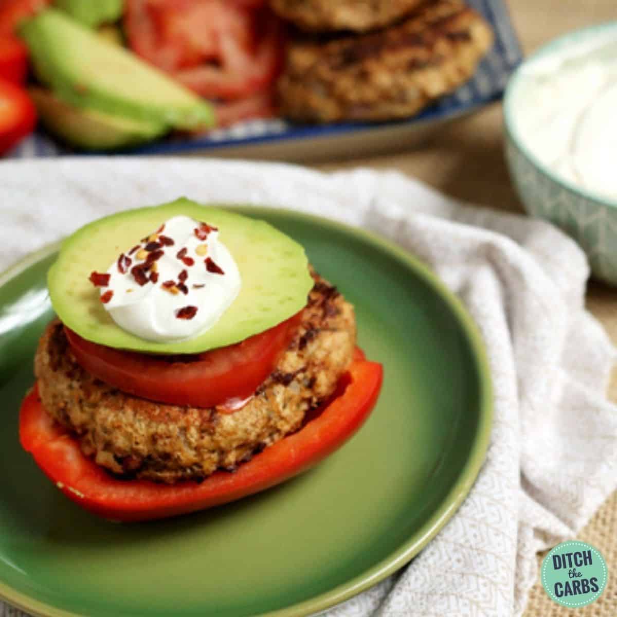 Low-carb Mexican chicken burger served with red pepper tomato avocado and cream cheese