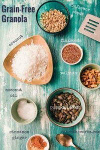 All the ingredients needed to make grain free granola on a blue board