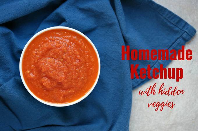 A bowl of homemade ketchup sitting on a blue cloth