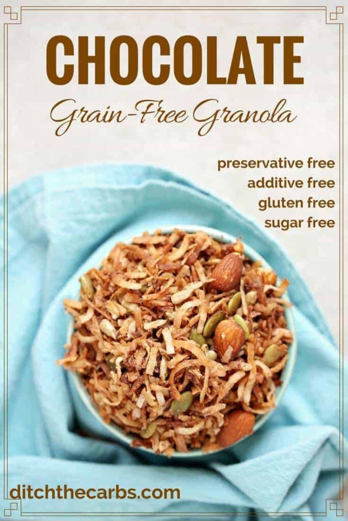 chocolate grain free granola in a bowl over a blue cloth napkin