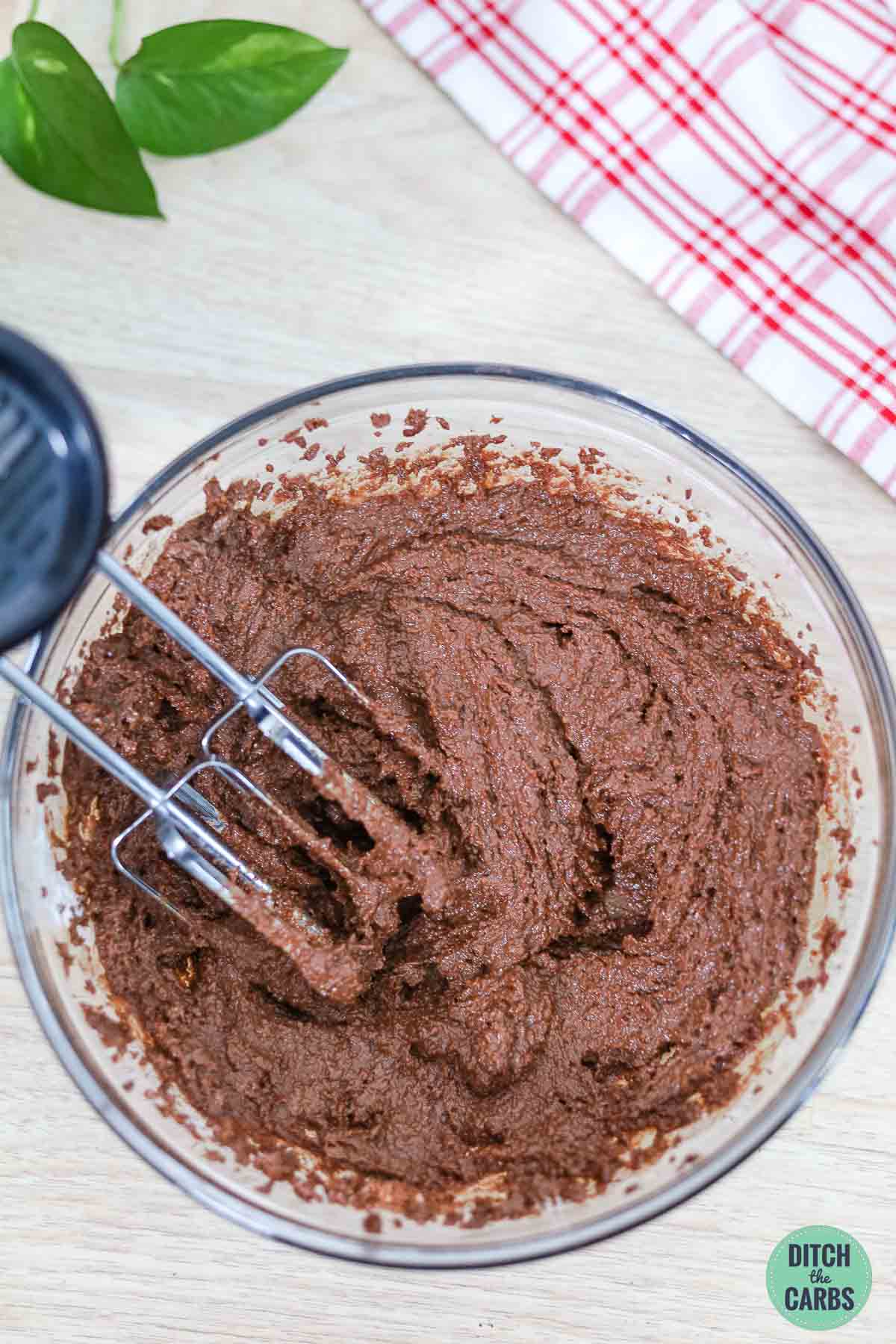 chocolate cupcake mixture i a glass mixing bowl
