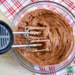 keto chocolate frosting in a mixing bowl with an electric mixer