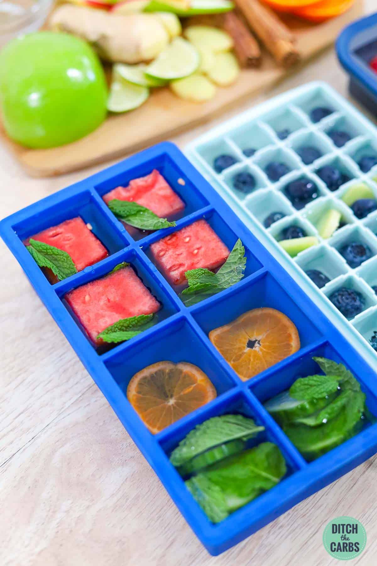 ice cube trays with frozen fruit