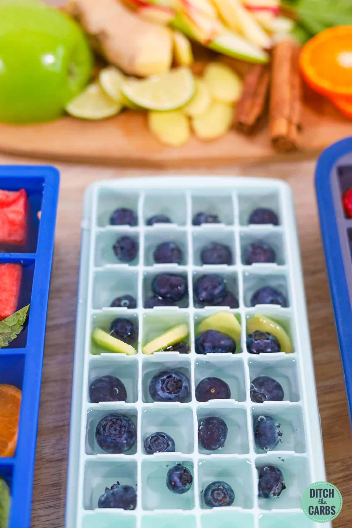 ice cube trays with frozen fruit