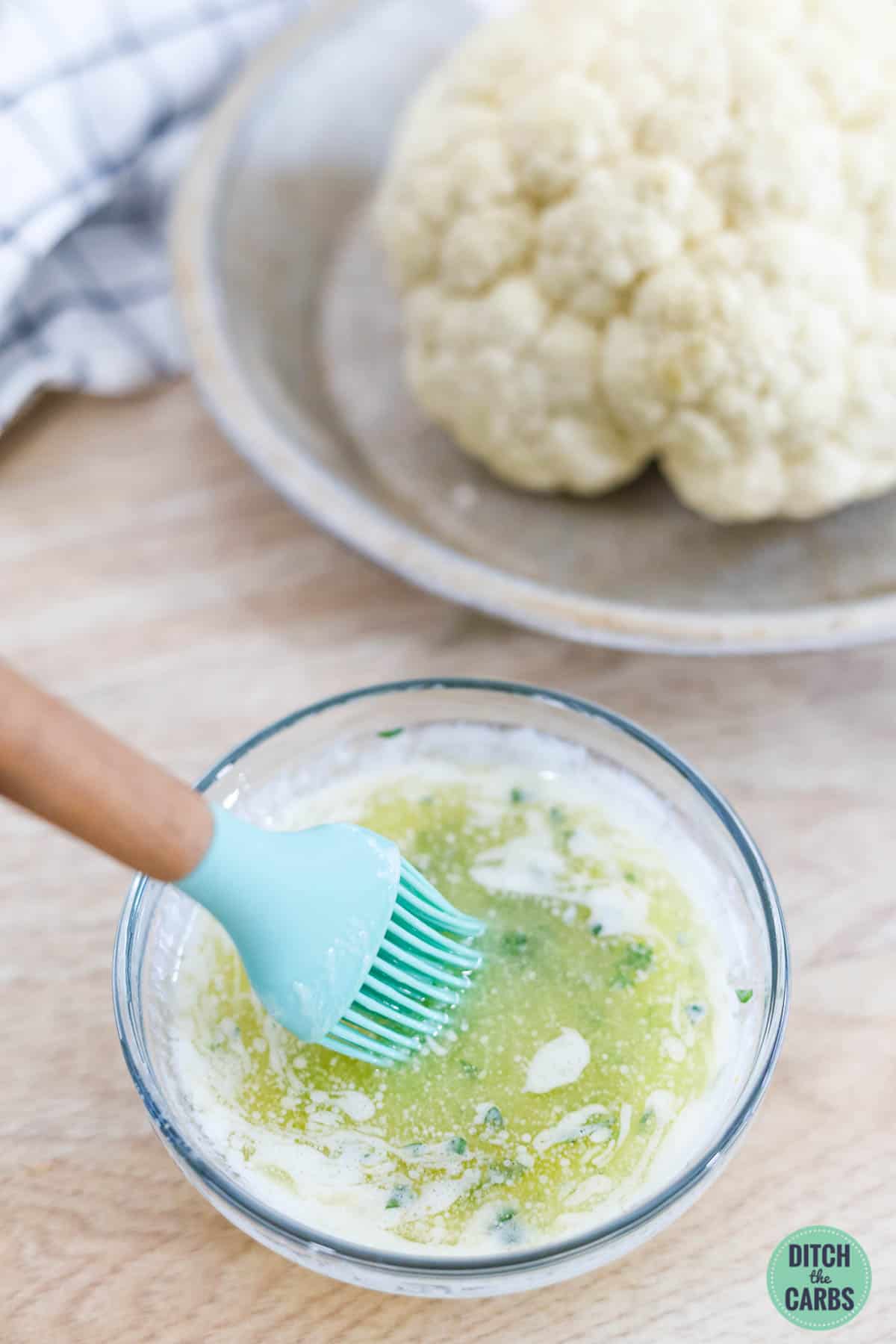 melted herbed garlic butter in a small mixing bowl