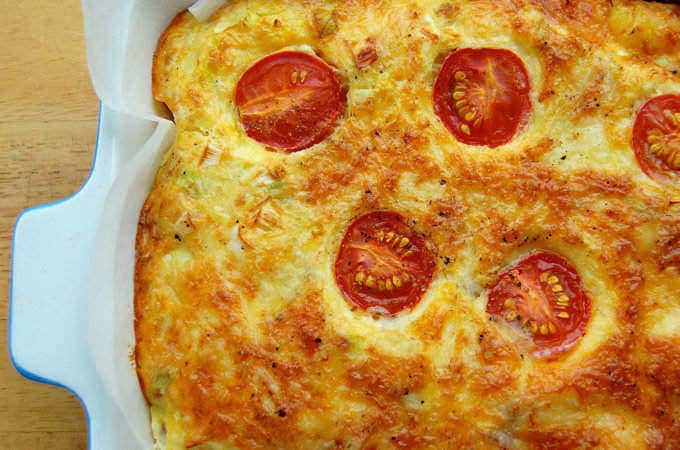 Crustless Bacon and Egg Pie baked with sliced cherry tomatoes