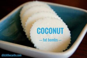 4 coconut fat bombs sitting on a small blue dish