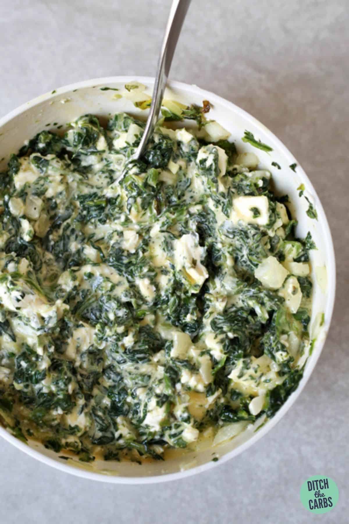 spinach and feta mixing in a large mixing bowl