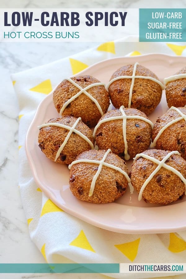 A pink plate with low-carb hot cross buns and a white frosting cross