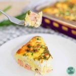 Sliced squares of salmon quiche with a fork