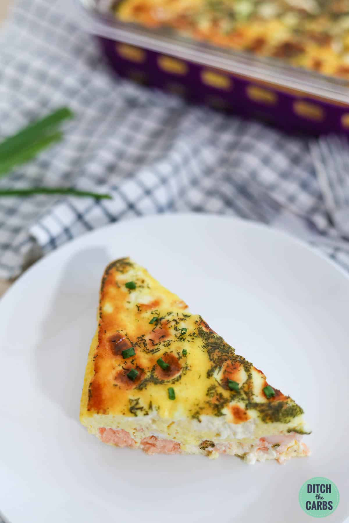 a slice of crustless salmon quiche on a white plate