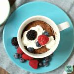 1 minute low carb mug cakes sitting on a blue plate and a wooden chopping board