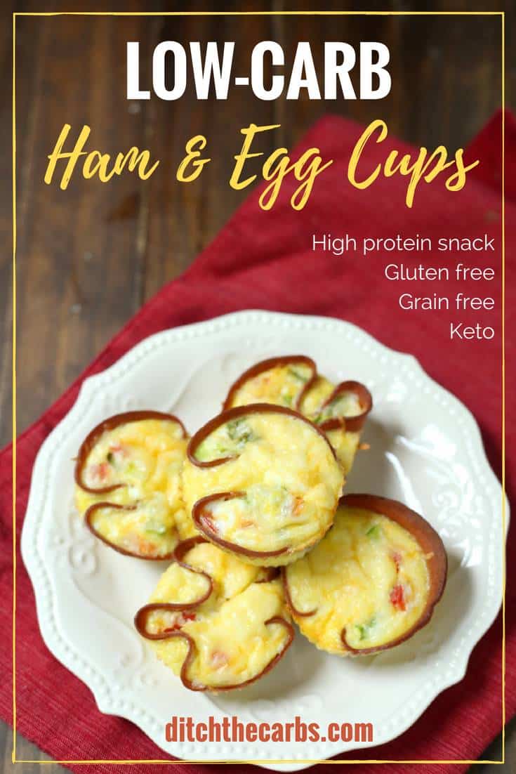 low-carb ham and egg cups on a white dish sitting on a red cloth