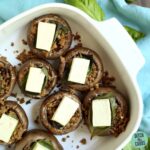 Stuffed mushrooms put on an antique white plate with fresh basil