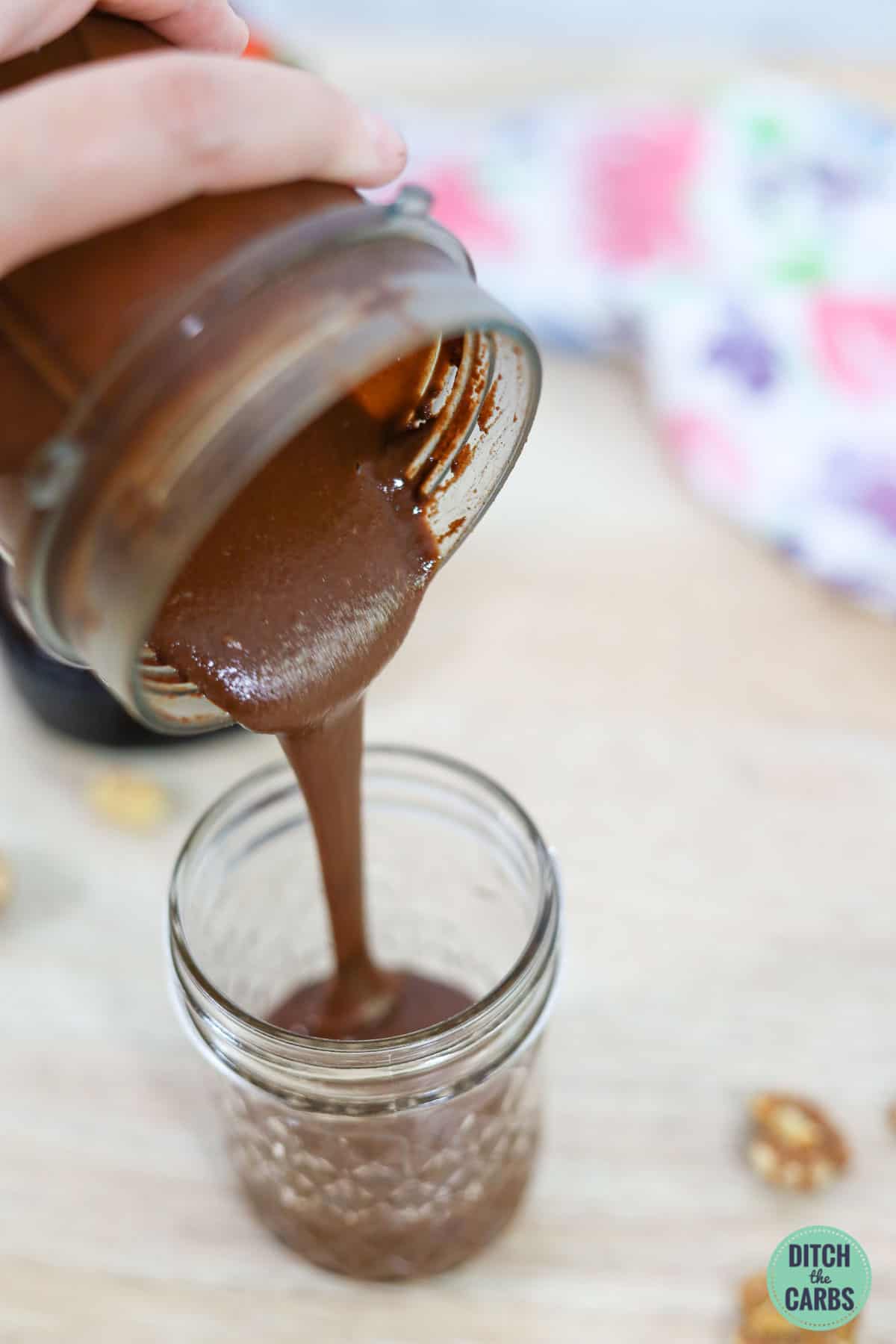 pouring a jar of sugar-free Nutella
