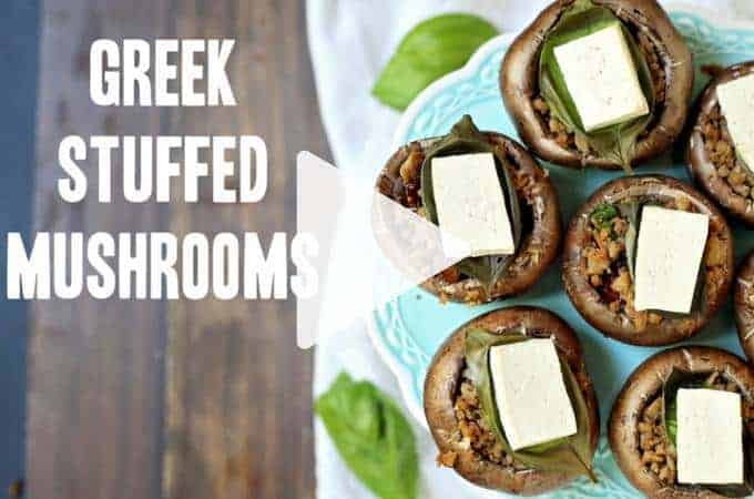 Stuffed mushrooms put on an antique blue plate with fresh basil