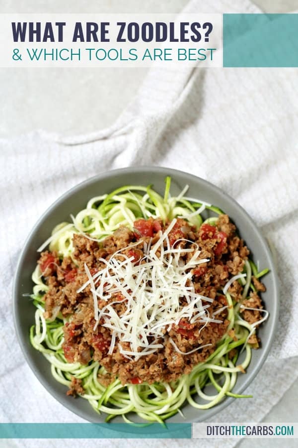 A bowl of spaghetti Bolognese meat sauce served on zucchini noodles and shredded cheese on top