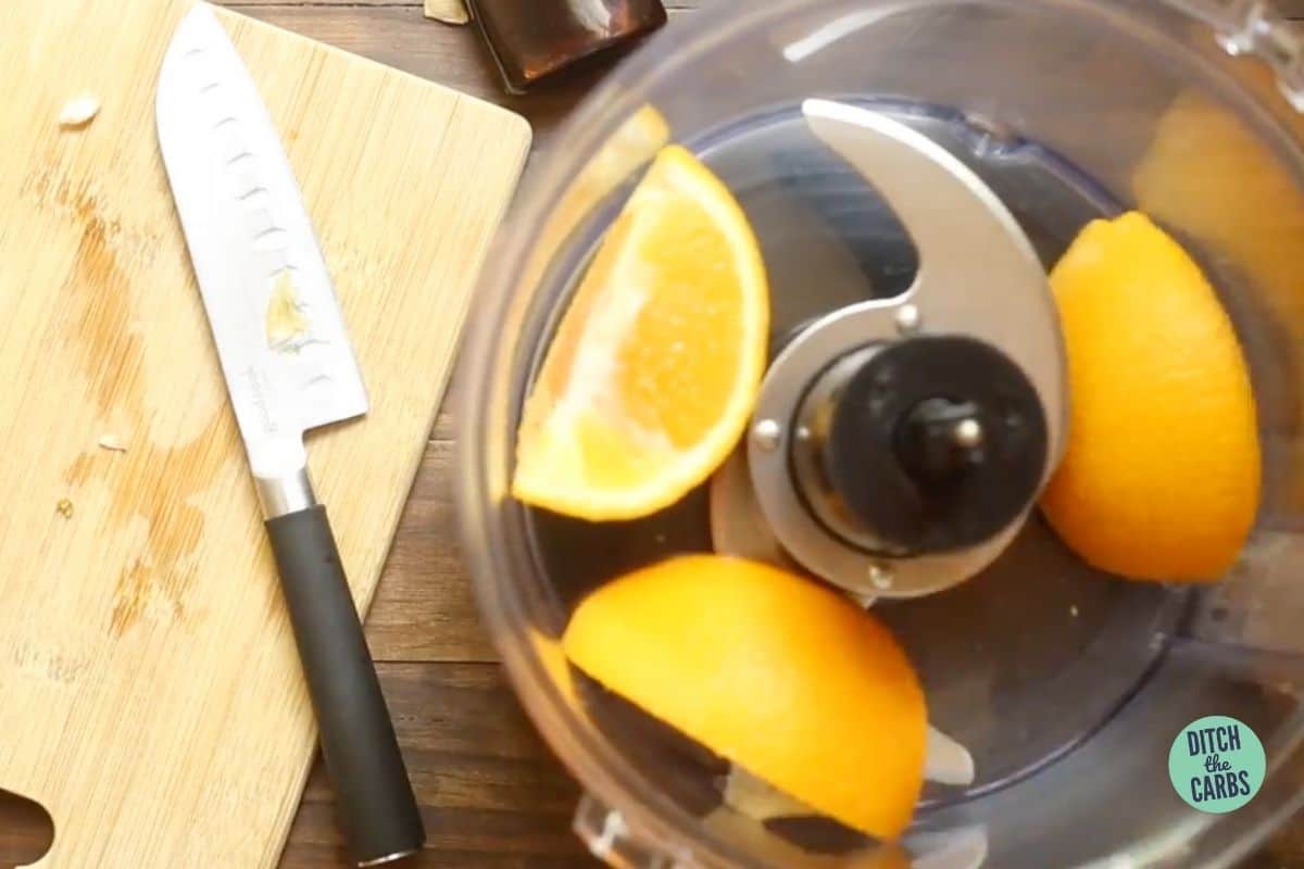 quartered oranges in a food processor