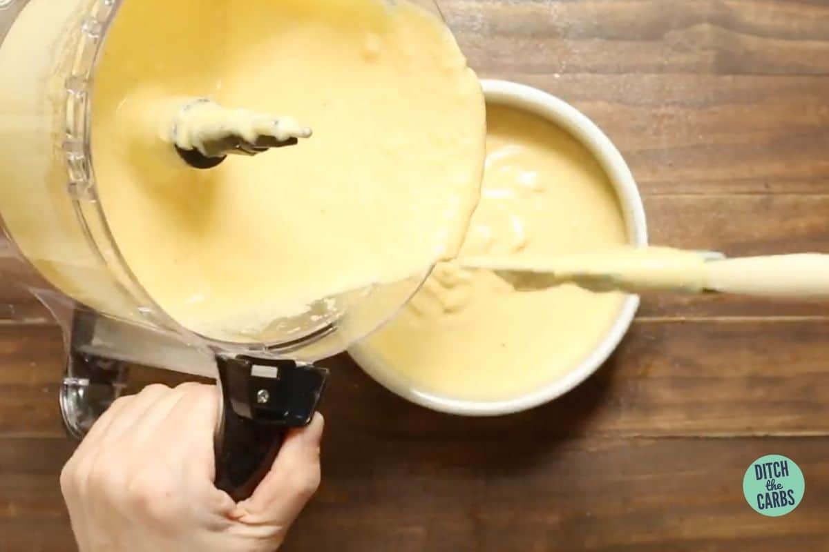 pouring cake batter into a cake pan