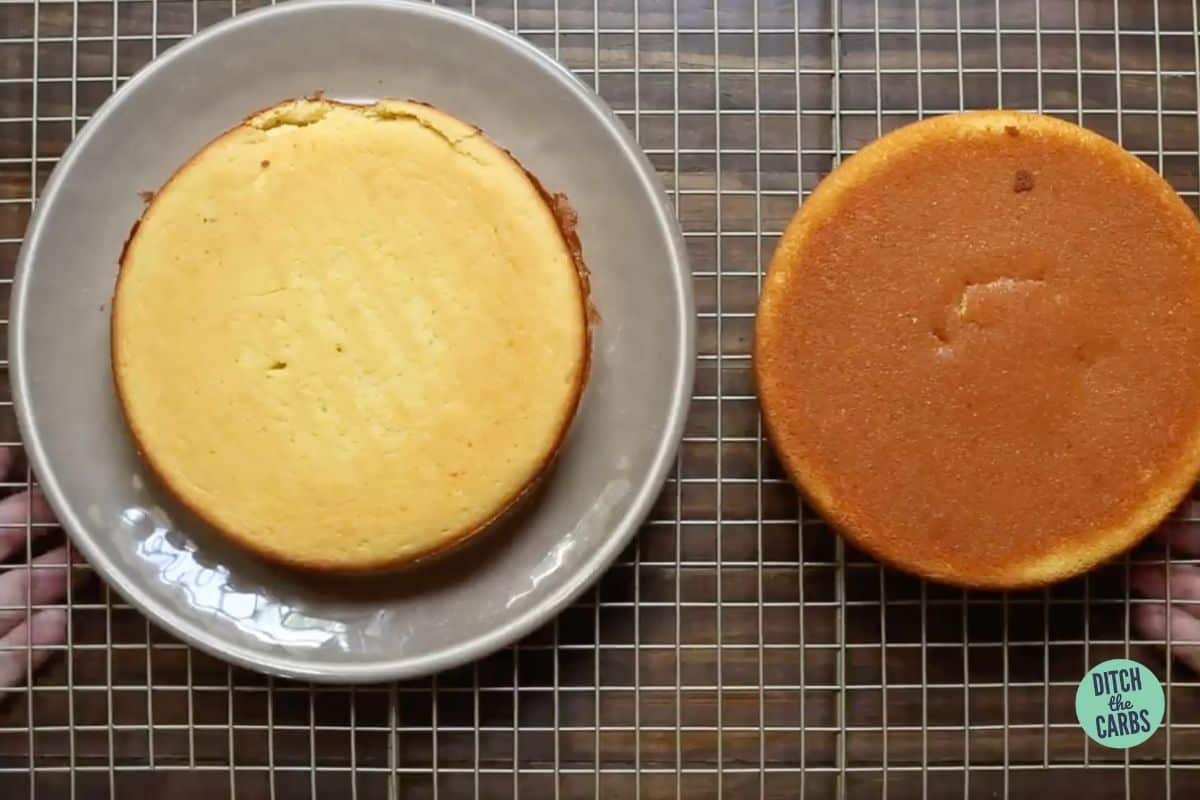 two orange cakes on a wire rack