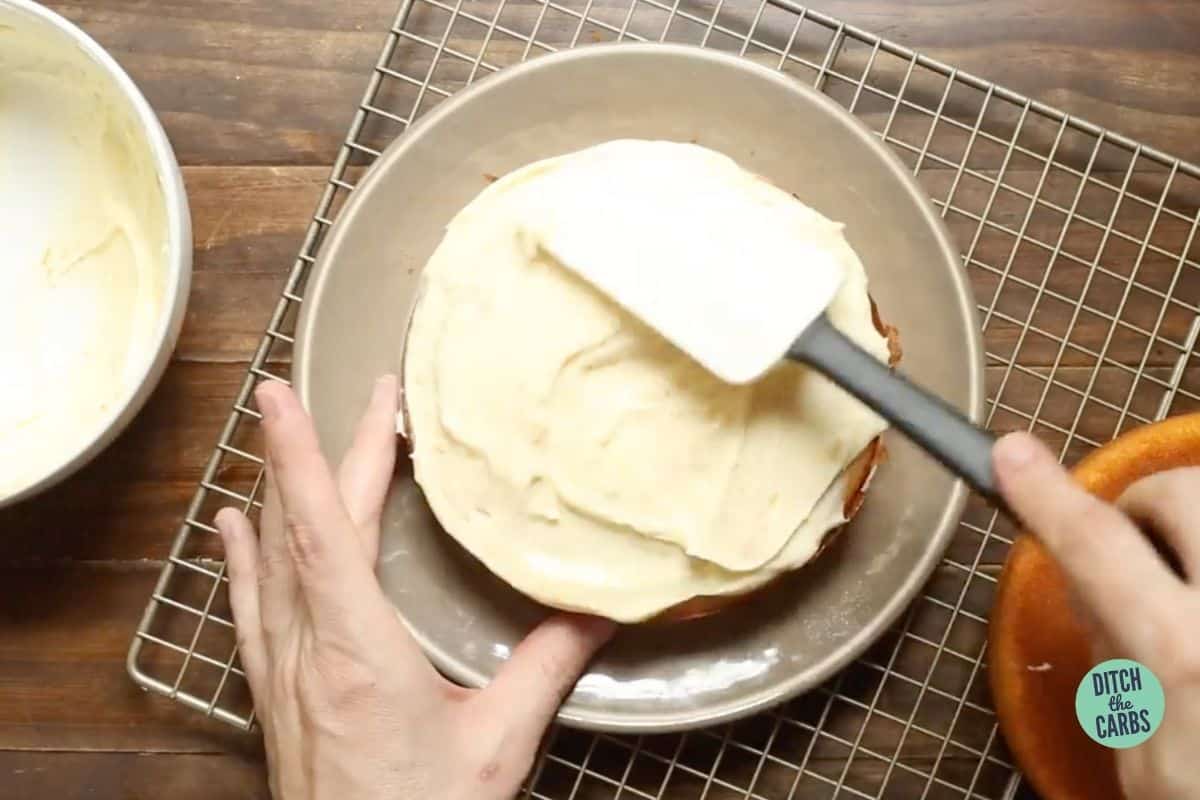 frosting and decorating an orange cake