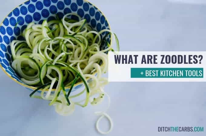 Zucchini noodles sitting in the bowl and spilling onto the kitchen bench