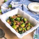 Brussels sprouts in a white serving dish