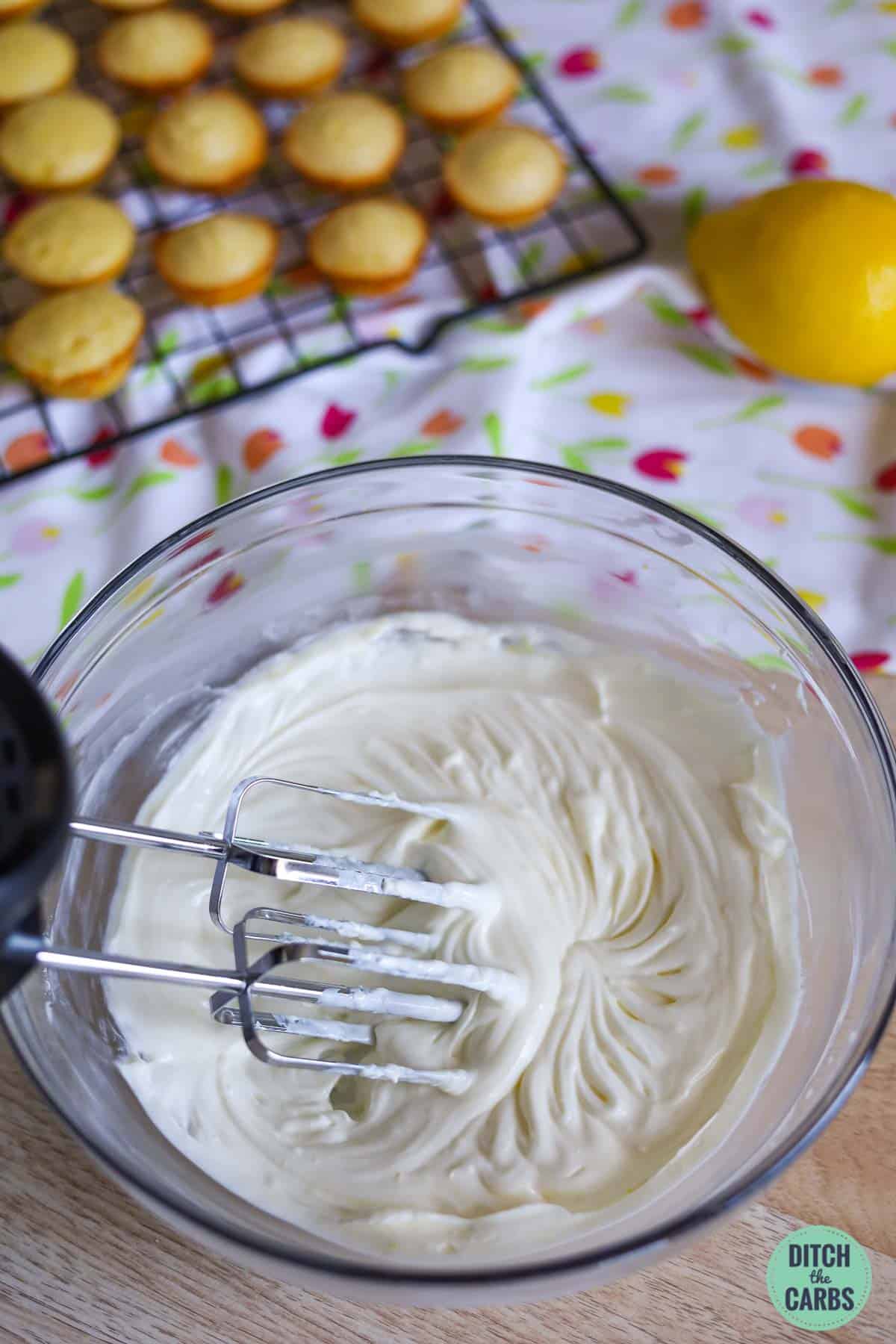 cream cheese and yoghurt in a mixing bowl with a hand mixer