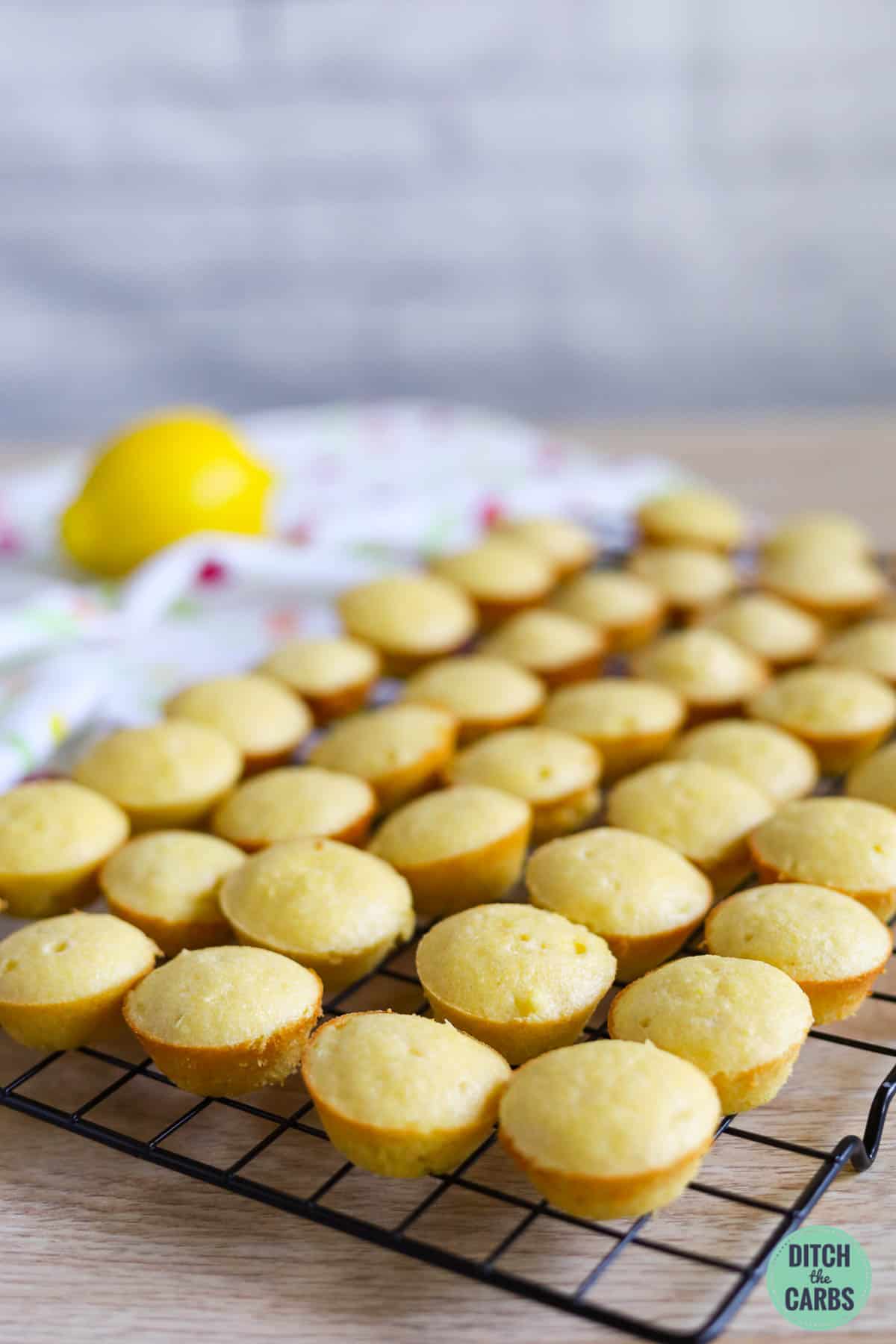 baked keto lemon cupcakes on a wore cooling rack