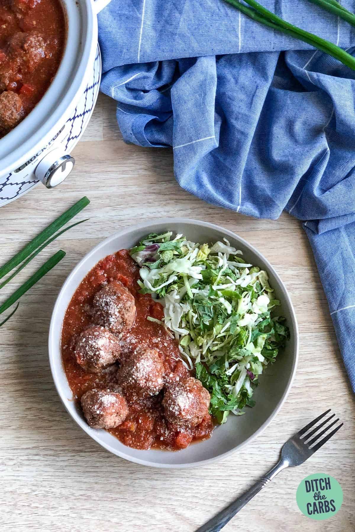 keto self-saucing meatballs served in a bowl with sliced cabbage