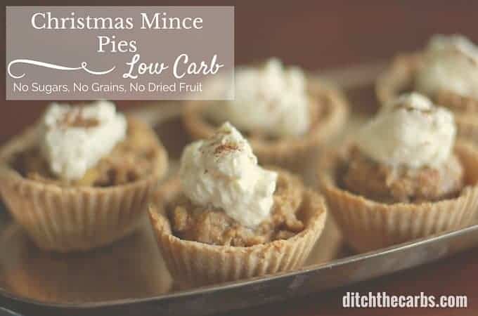 A close up of a low-carb Christmas fruit mince pie served with brandy whipped cream