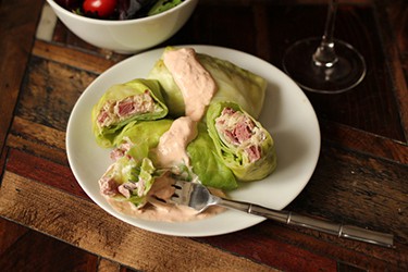 ham and cheese wrapped in lettuce with a creamy sauce