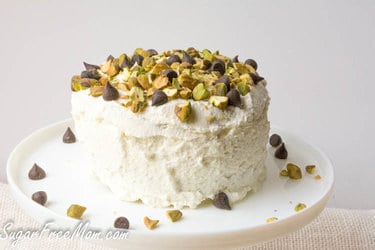 Cannoli mug cake decorated with frosting and crushed pistachios