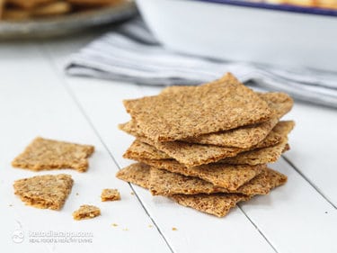 Pile of crackers on a white wooden board