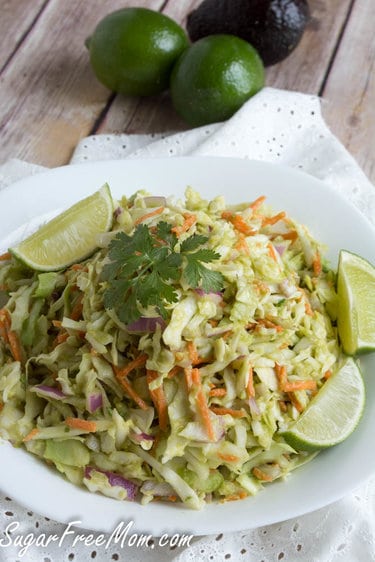 Avocado coleslaw served with lime wedges