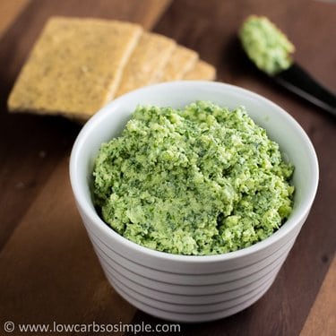 Cheesy kale spread with crackers and a knife