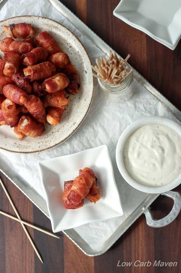 A plate of chicken wrapped in bacon served with chipotle mayonnaise