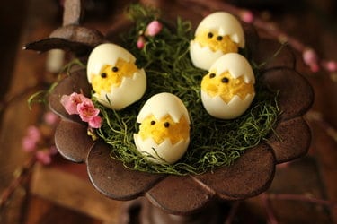 Boiled eggs decorated to look like baby chickens
