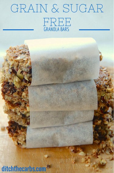 Granola bars wrapped and stacked on a bread board
