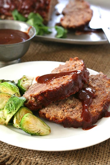 A plate of meatloaf and barbecue sauce