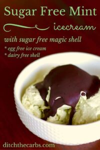 Sugar free mint ice cream with a sugar free magic shell served in a white bowl on a dark wooden table