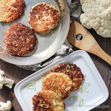 A bunch of food on a plate, with Cauliflower and Falafel