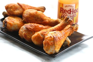 A tray of baked chicken drumsticks