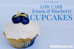 Close up of a low-carb cupcake frosted and a blueberry on top