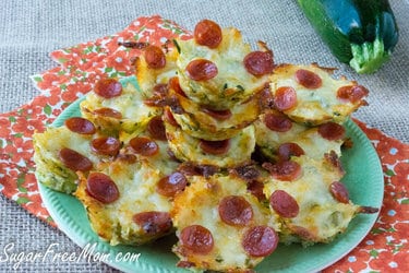 Zucchin pizza bites sitting on top of a plate of food 