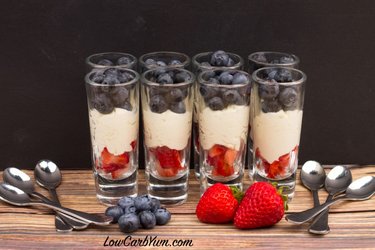 Fresh berries in tall glasses with whipped cream